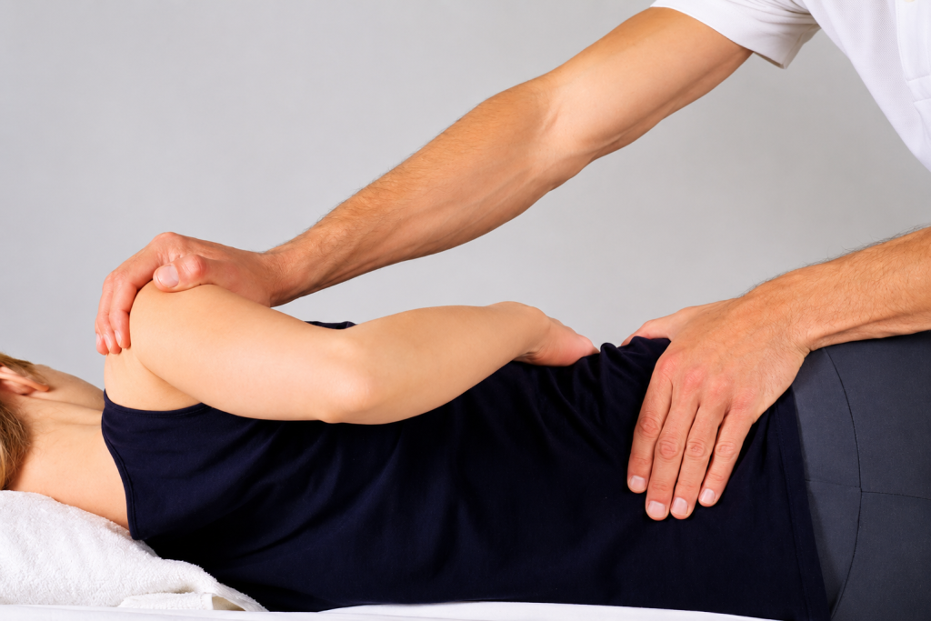 Healthcare provider performing a chiropractic shoulder and spinal adjustment to improve joint mobility, reduce pain, and restore musculoskeletal function.