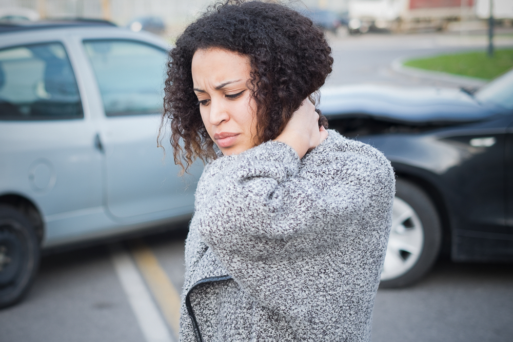 Chiropractor examining a patient's neck for whiplash and soft tissue injuries after a car accident in Steele Creek, Charlotte, NC.