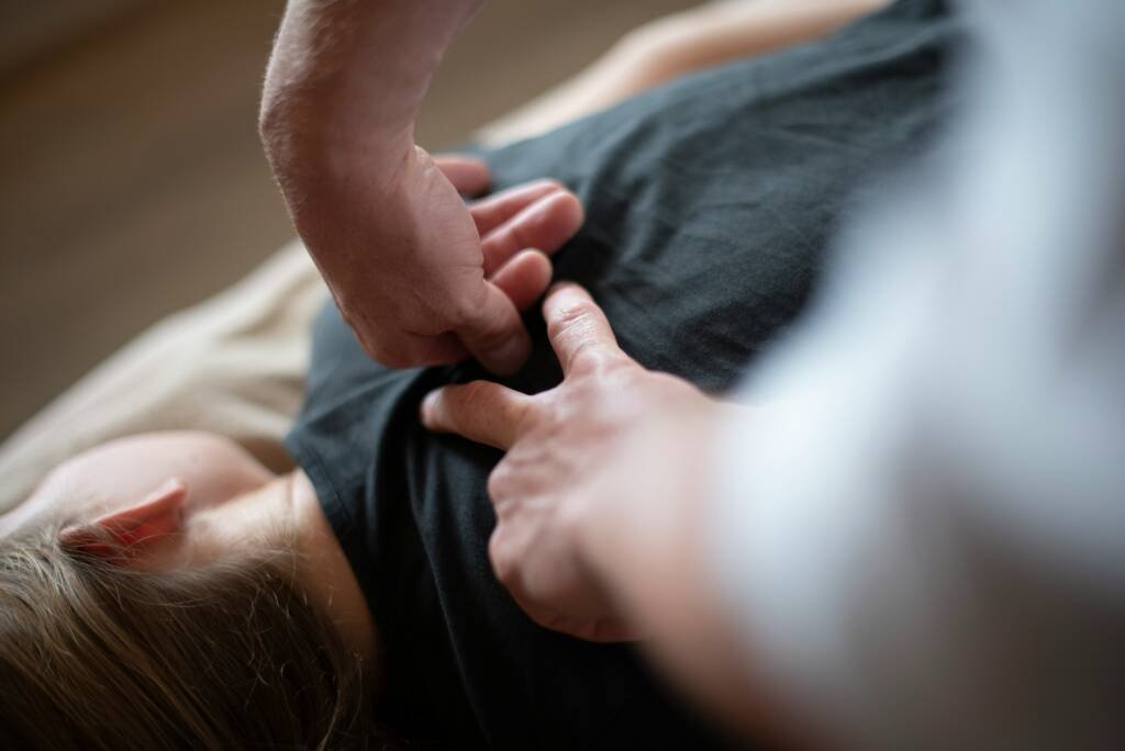 Chiropractor performing a manual adjustment on a patient recovering from a workplace injury