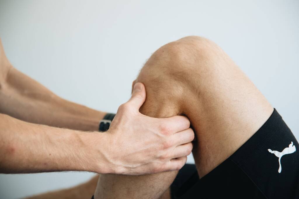Patient receiving an evaluation for knee pain at Urgent Chiropractic of Steele Creek
