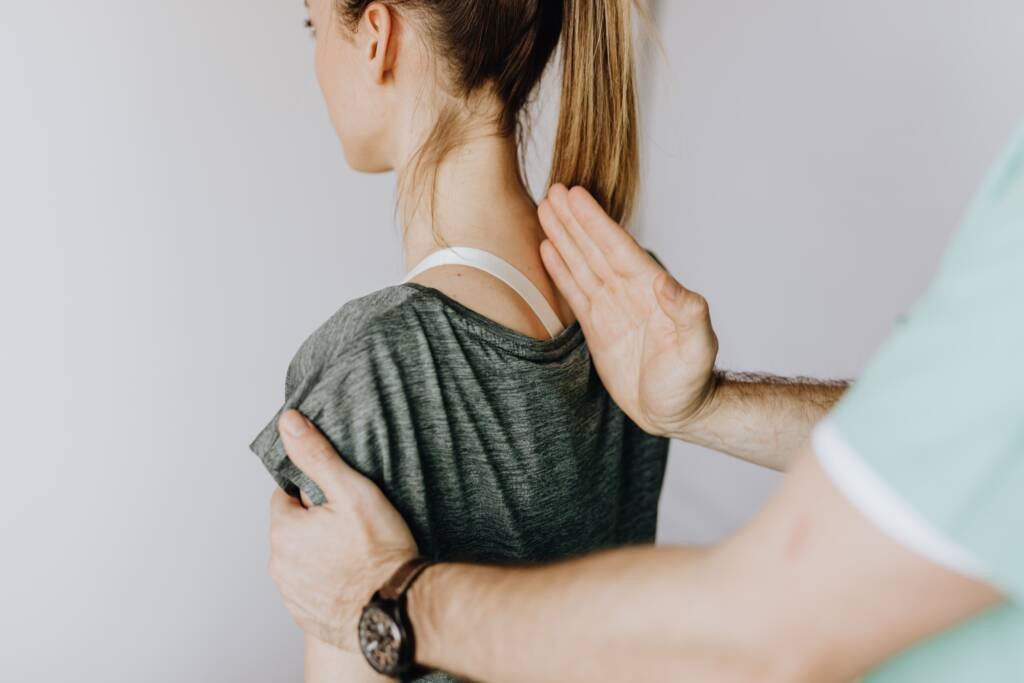 Chiropractic provider evaluating a patient with back pain in Steele Creek