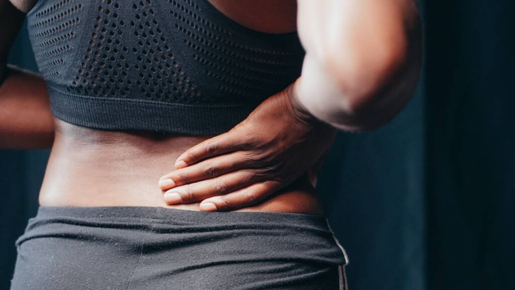 Patient receiving an evaluation for back pain at Urgent Chiropractic of Steele Creek