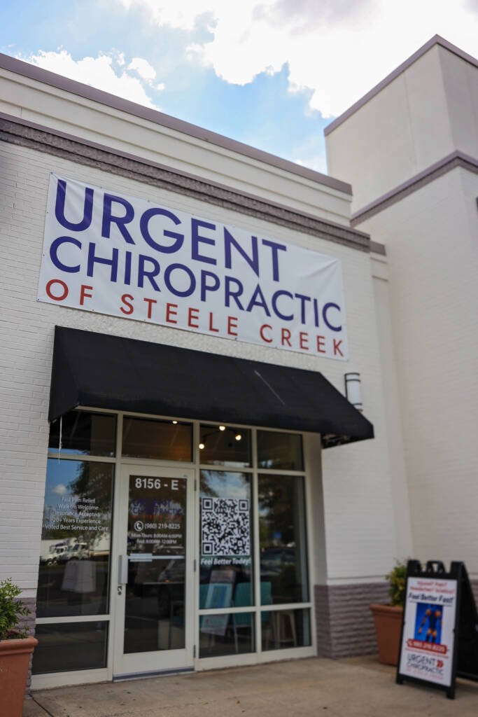 Storefront of Urgent Chiropractic of Steele Creek with the office sign above the entrance, seen from an angle