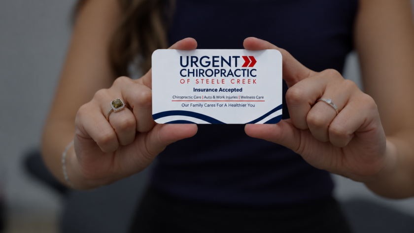 Our chiropractor in Steele Creek, Charlotte, NC, holding a spinal model during a chiropractic consultation.