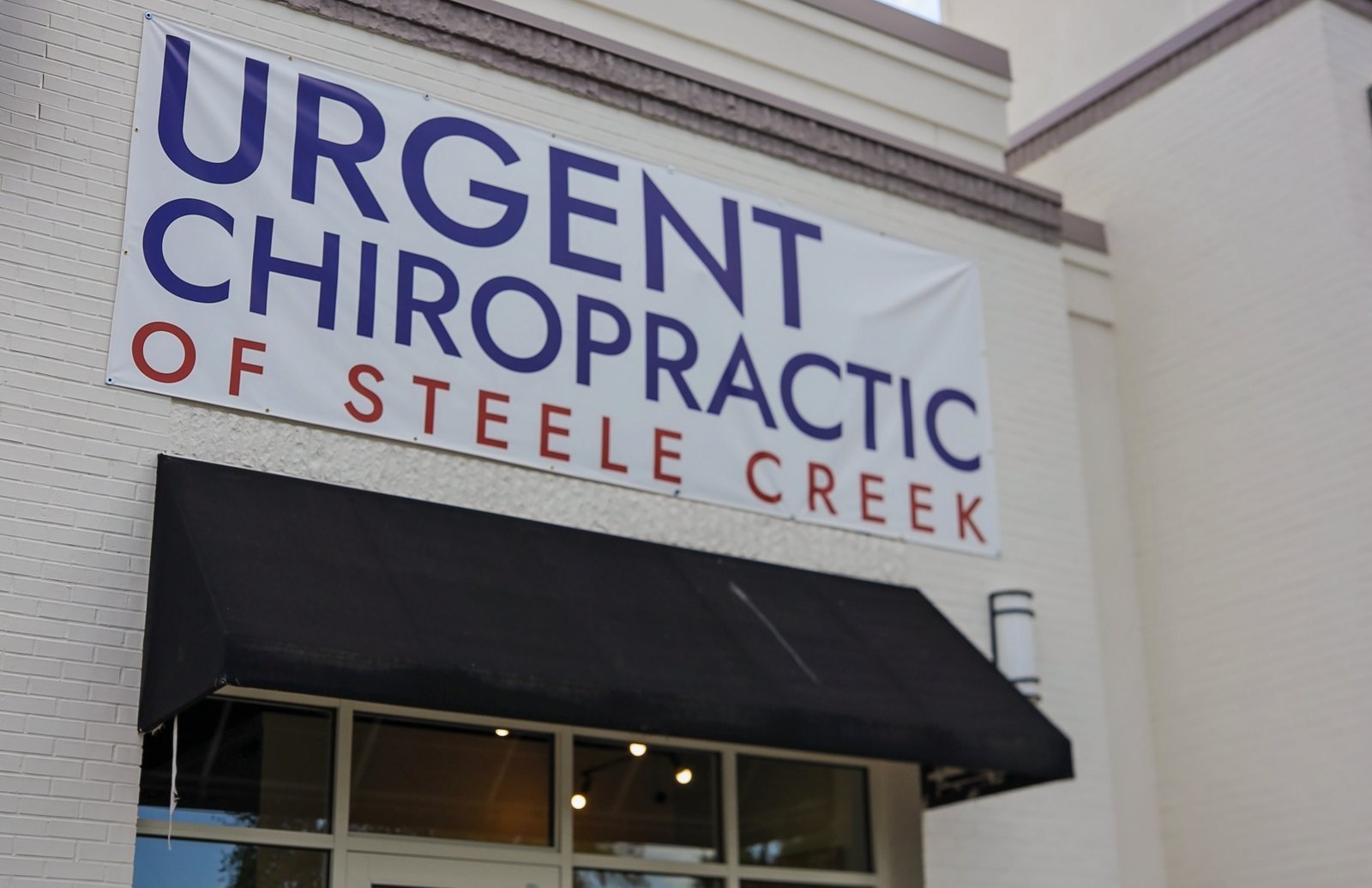 Urgent Chiropractic of Steele Creek sign above the office entrance on South Tryon Street
